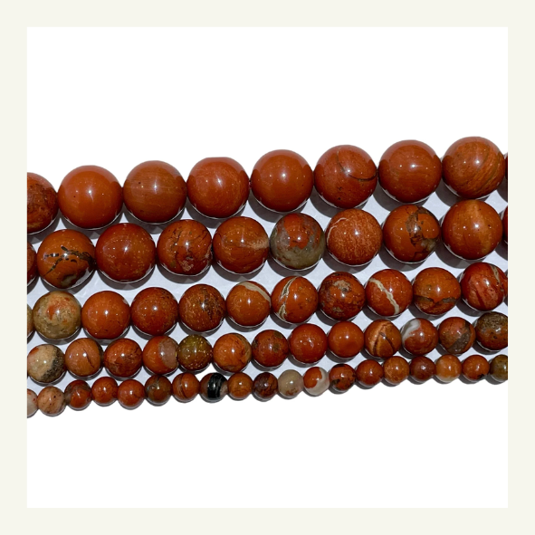 Perle de jaspe rouge, pierre semi-précieuse aux teintes rouges et terreuses, ajoutée aux attrape-rêves pour leur élégance.